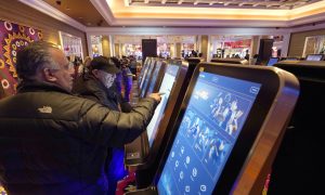 Sports bettors at Encore Boston Harbor, one of three Massachusetts casinos fined for accepting bets on in-state college basketball teams.