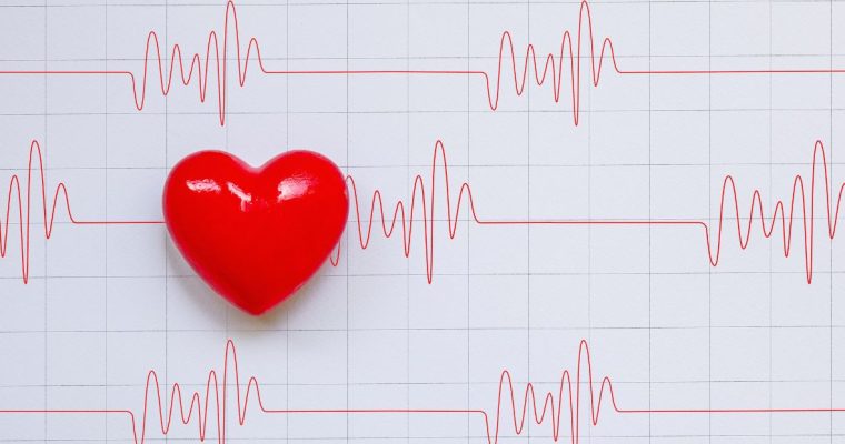 a series of cardiogram beats on a chart with a heart on the left