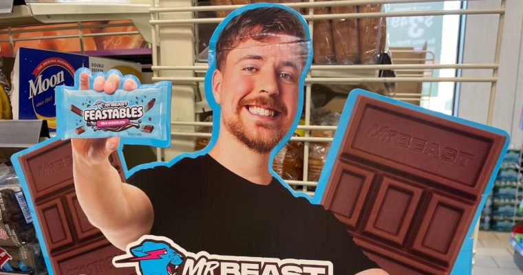 a carboard ad featuring mrbeast and his feastables candy bar