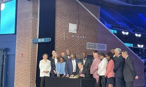 Gov. Roy Cooper signs the North Carolina sports betting bill at Spectrum Center in Charlotte.