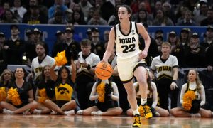 Iowa Hawkeyes basketball player Caitlin Clark plays against UConn in a 2024 Final Four matchup.