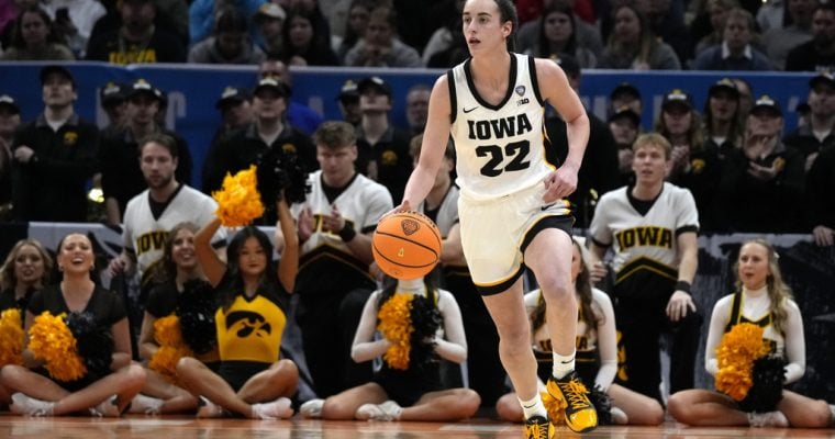 Iowa Hawkeyes basketball player Caitlin Clark plays against UConn in a 2024 Final Four matchup.