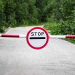 a stop sign and barrier on a road