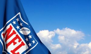 The flag with the NFL logo on background of sky