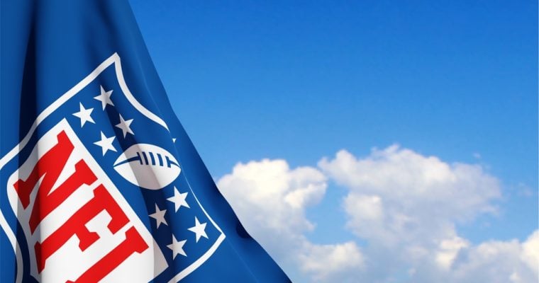 The flag with the NFL logo on background of sky