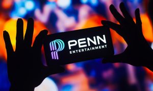In this photo illustration, the Penn Entertainment logo is displayed on a smartphone mobile screen