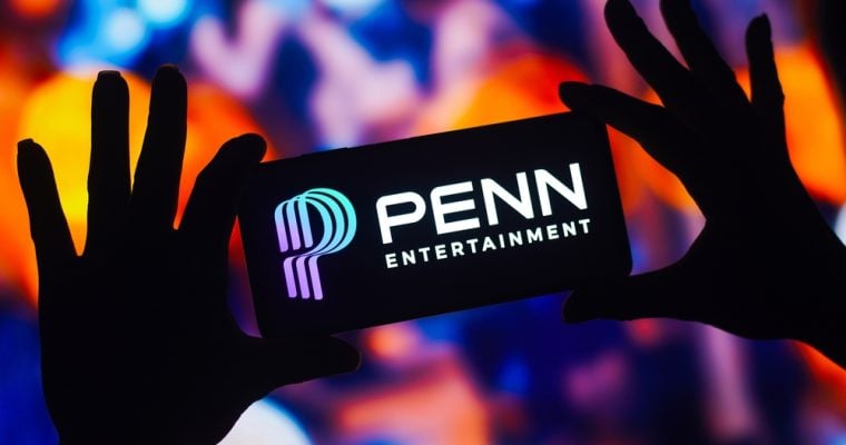 In this photo illustration, the Penn Entertainment logo is displayed on a smartphone mobile screen