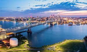 Ben Franklin Bridge and Philadelphia skyline at dusk viewed from above Cooper's Poynt Park, in Camden. Ben Franklin Bridge is a suspension bridge connecting Philadelphia and Camden, NJ.