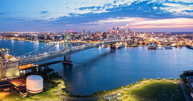 Ben Franklin Bridge and Philadelphia skyline at dusk viewed from above Cooper's Poynt Park, in Camden. Ben Franklin Bridge is a suspension bridge connecting Philadelphia and Camden, NJ.