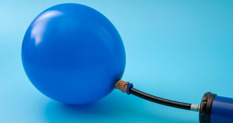 a blue balloon being pumped up