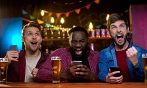 Excited,Friends,Rejoicing,Watching,Horse,Race,And,Making,Bets,Online,