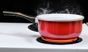 a boiling red pot on a stove