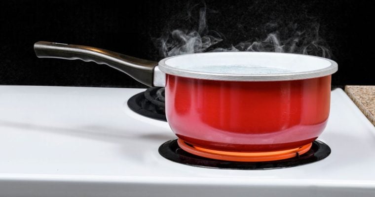 a boiling red pot on a stove