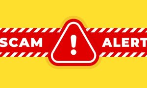 a red scam alert warning over a yellow background