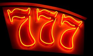 three sevens in neon red