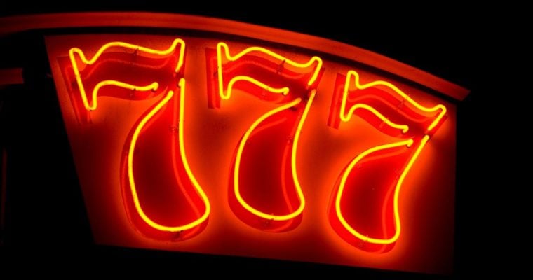 three sevens in neon red